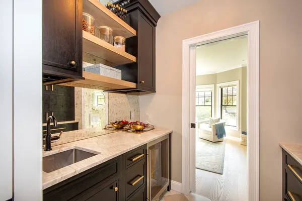 a kitchen with a sink and a stove with wooden floor
