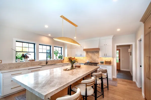 an open kitchen with a table and chairs in it