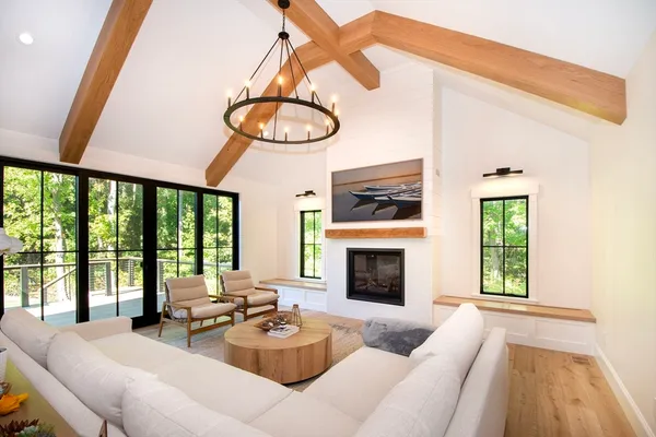a living room with furniture a fireplace and a large window