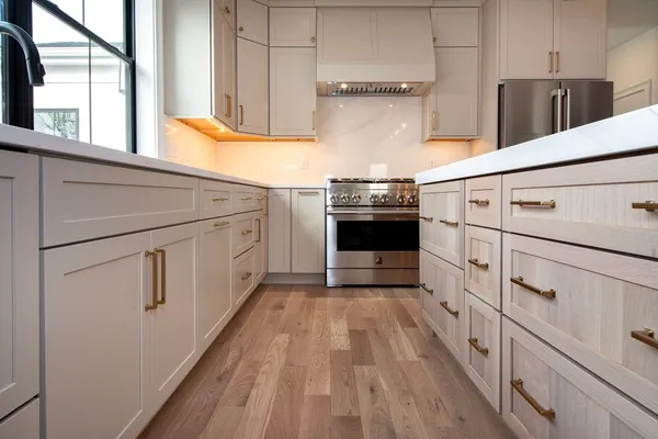 a kitchen with white cabinets and white appliances