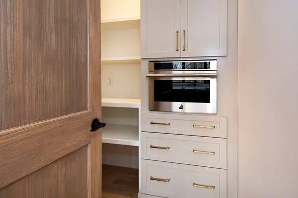 a kitchen with white cabinets and white appliances