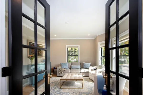 a living room with furniture and a floor to ceiling window