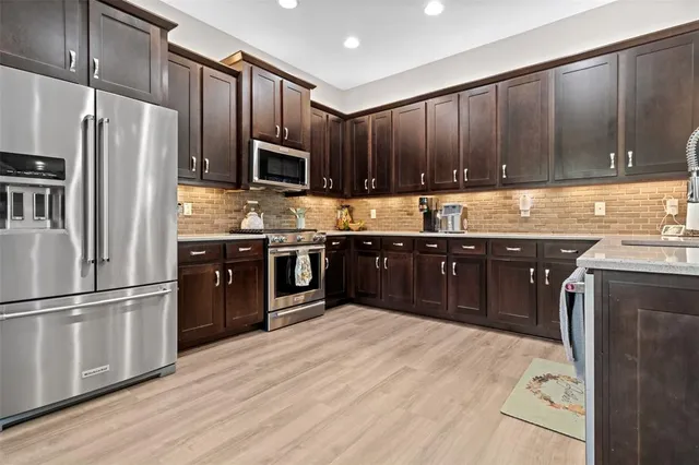 a living room with furniture and kitchen view