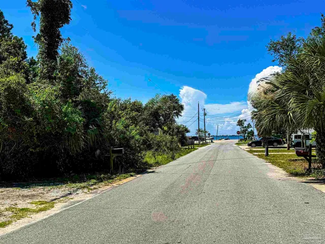 a view of a street with a building in the background