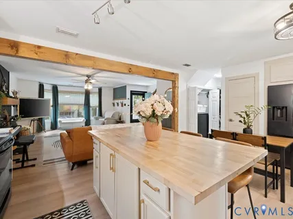 a view of living room kitchen with furniture and flat screen tv