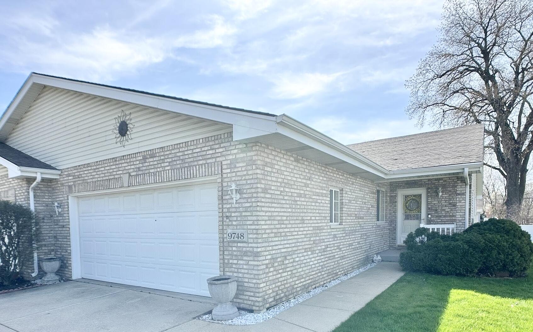 9748 Erie Street Highland, IN 46322 - Photo 1 of 14 a front view of a house with a yard and garage