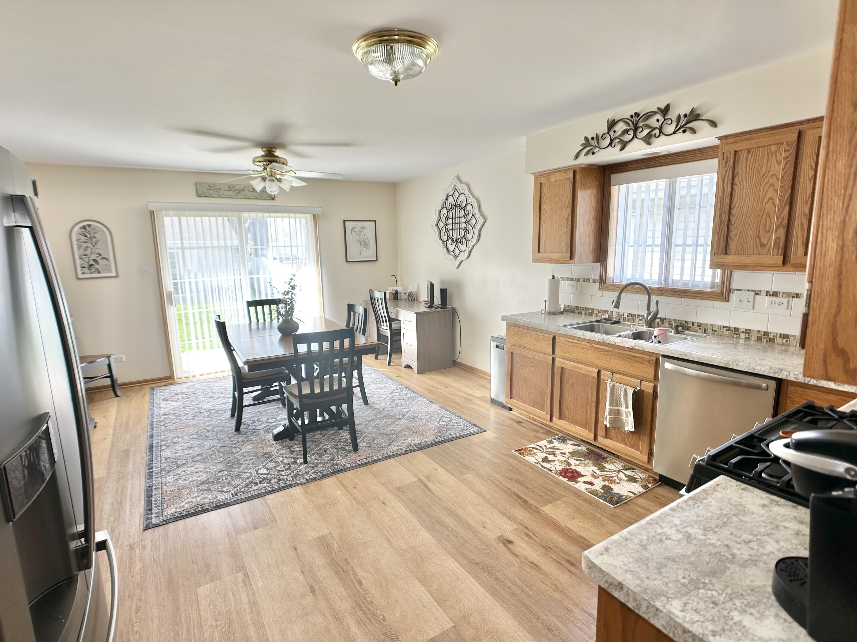 9748 Erie Street Highland, IN 46322 - Photo 3 of 14 a living room with stainless steel appliances granite countertop furniture a fireplace a rug and a window
