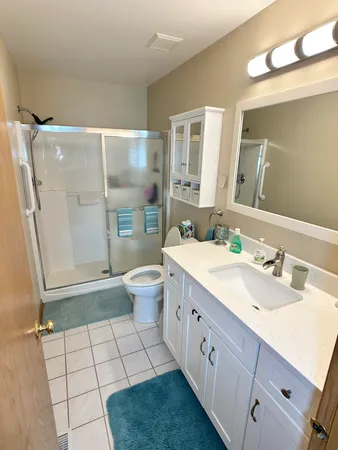 a bathroom with a double vanity sink mirror and toilet