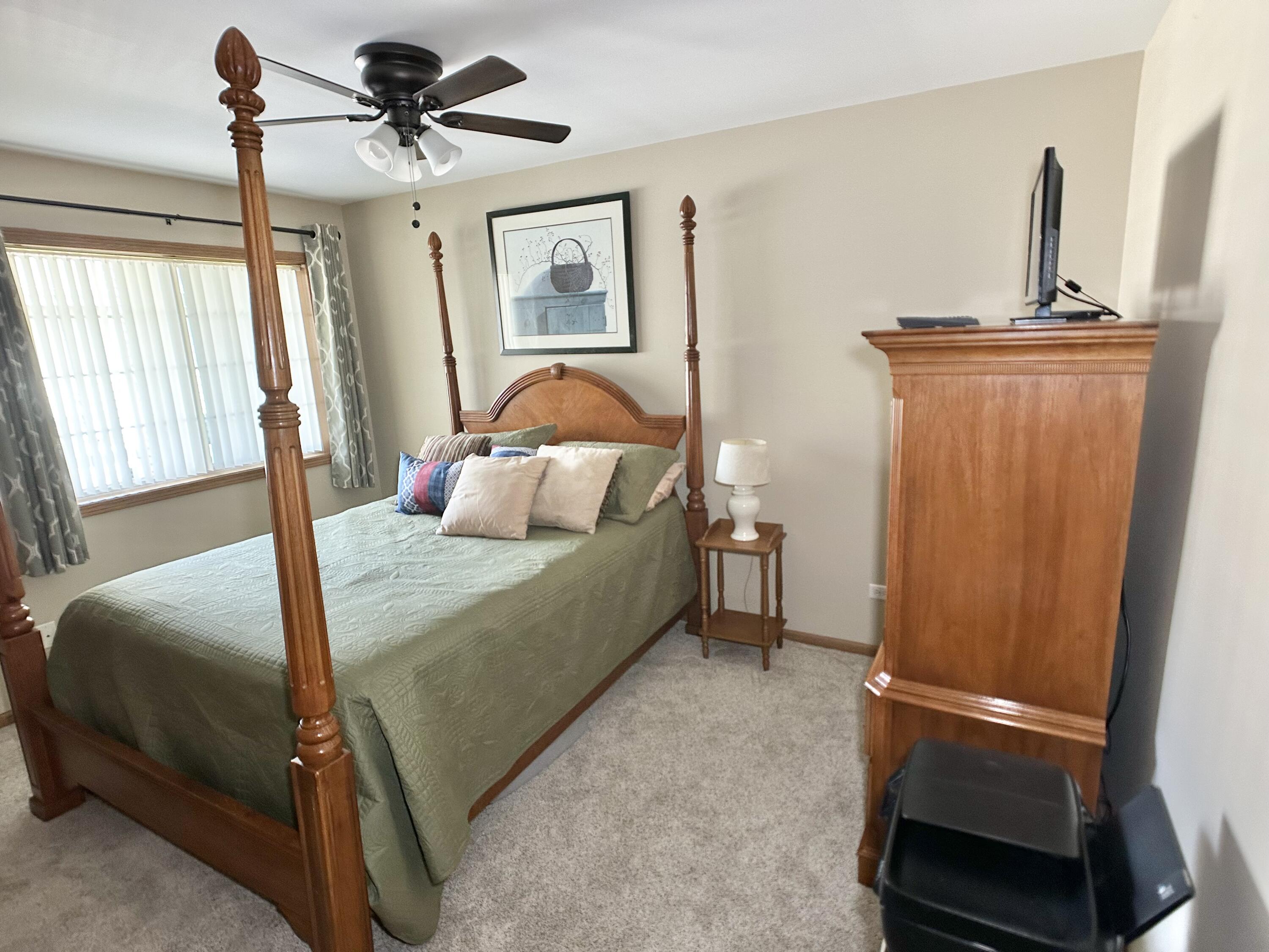 9748 Erie Street Highland, IN 46322 - Photo 9 of 14 a bedroom with a bed and a mirror