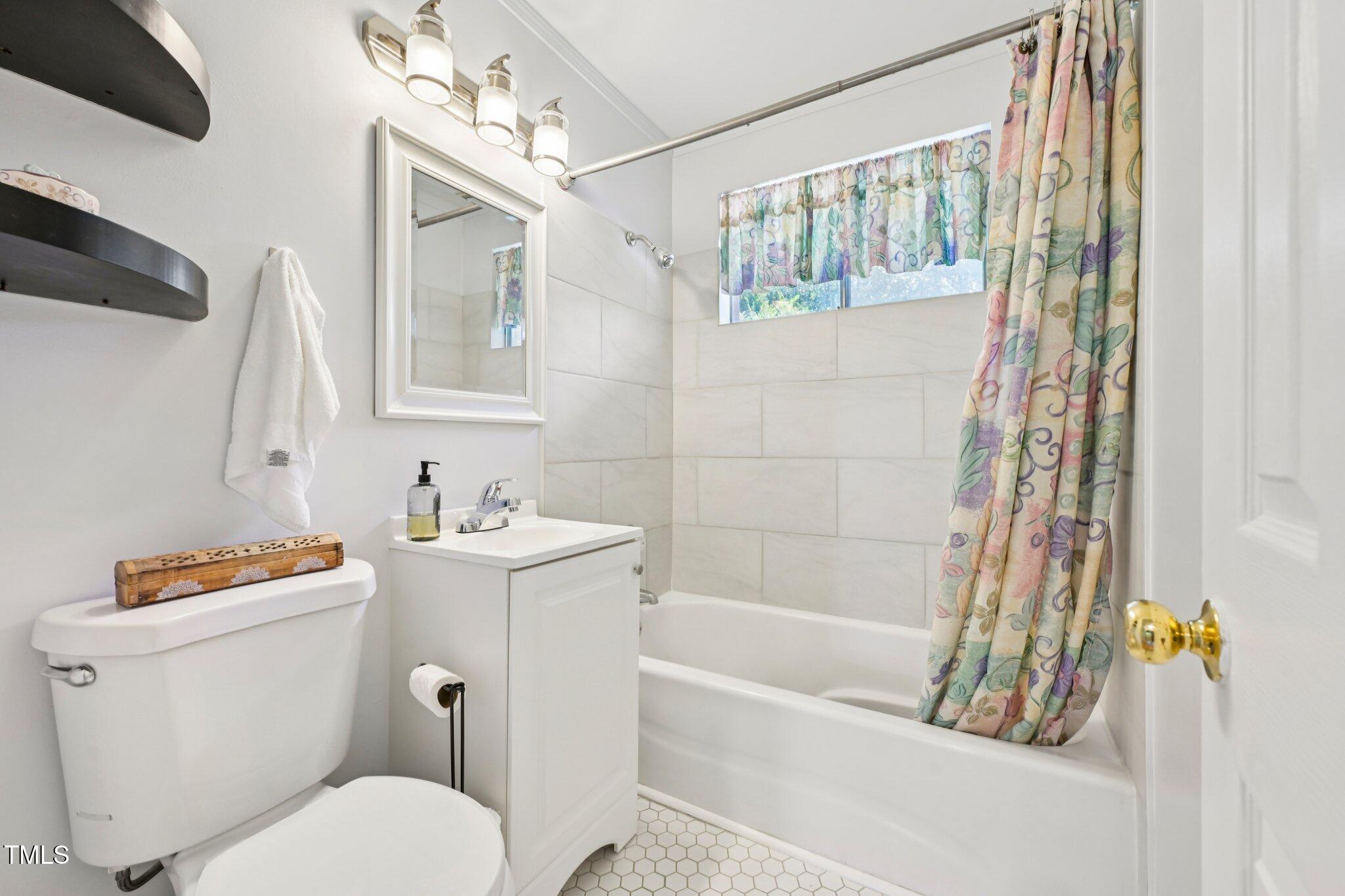 900 Newcombe Road Raleigh, NC 27610 - Photo 13 of 23 a bathroom with a sink toilet and shower