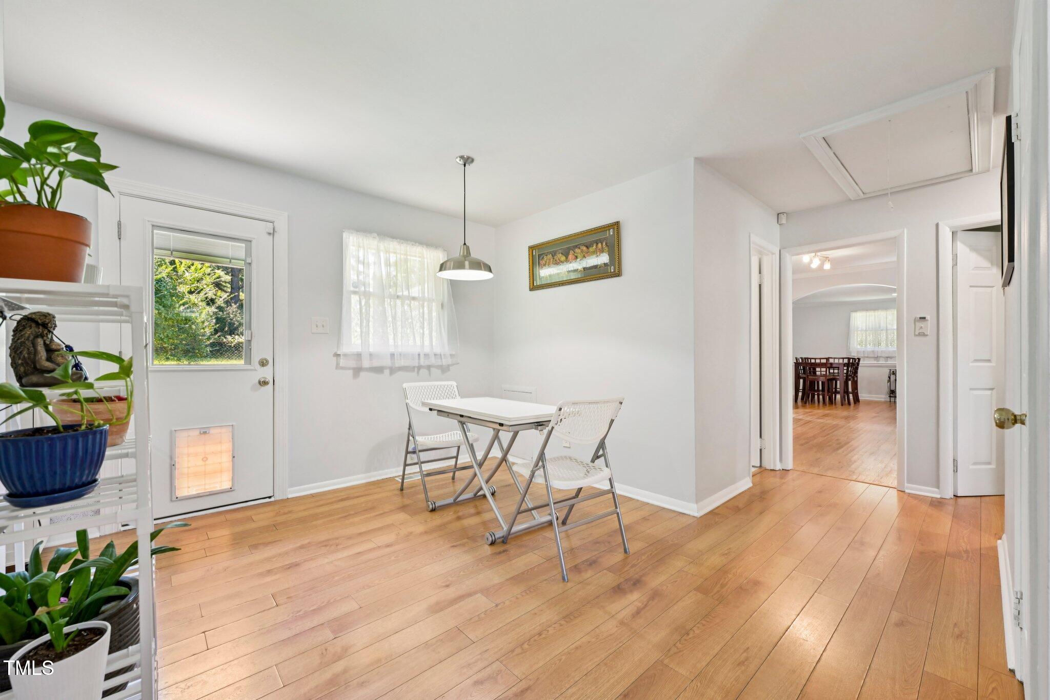 900 Newcombe Road Raleigh, NC 27610 - Photo 6 of 23 a view of a dining room with furniture window and wooden floor