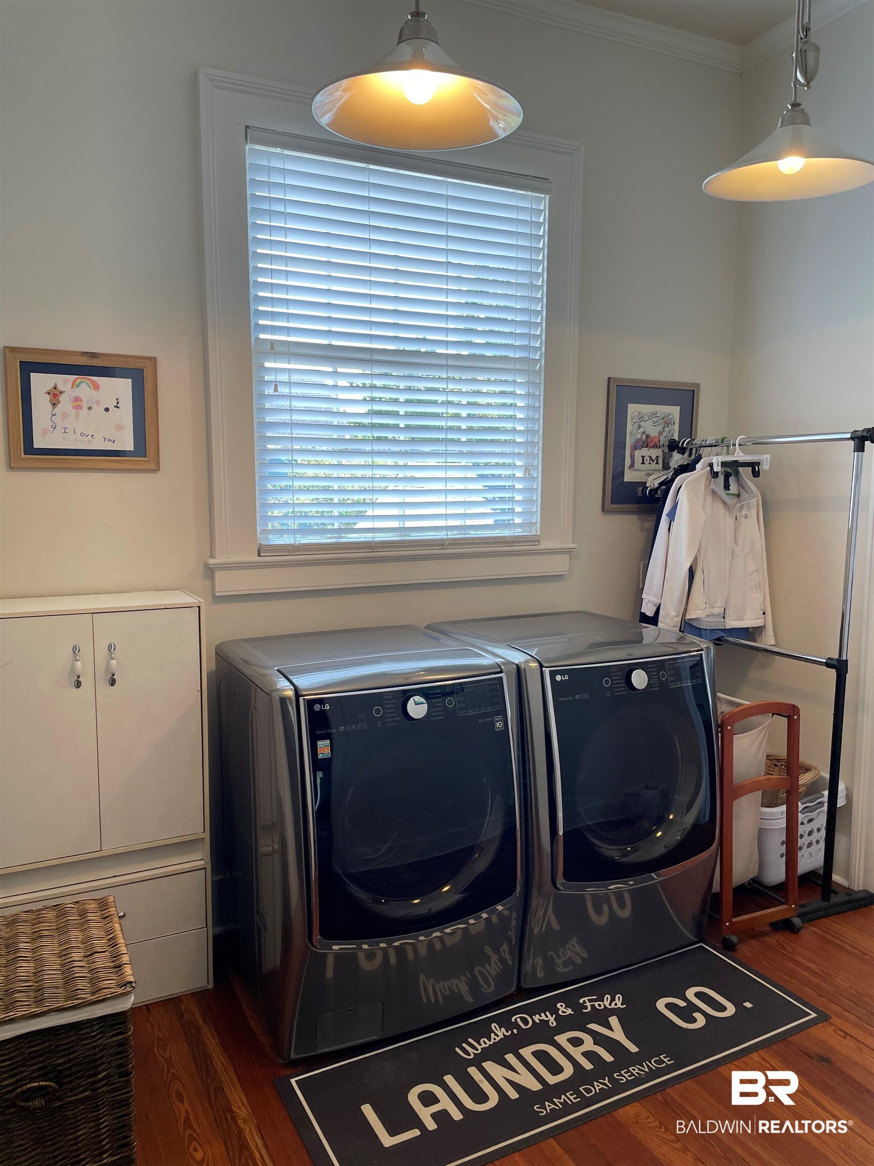 1001 Augusta Street Mobile, AL 36604 - Photo 13 of 26 Laundry room featuring washer and dryer, crown molding, and dark hardwood / wood-style flooring
