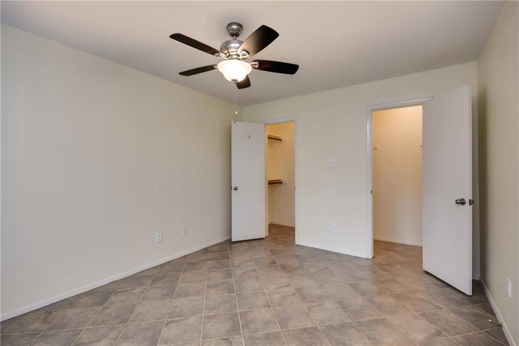 8210 Bent Tree Road, Unit 144 Austin, TX 78759 - Photo 11 of 24 an empty room with a ceiling fan and a window