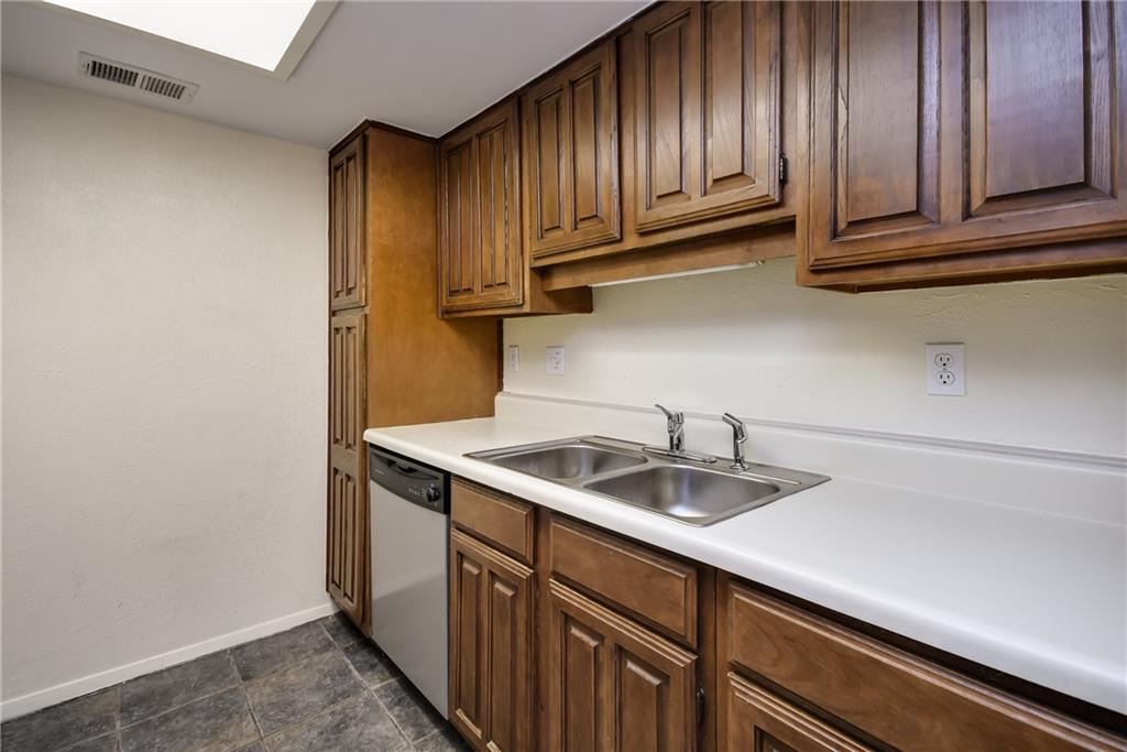 8210 Bent Tree Road, Unit 144 Austin, TX 78759 - Photo 16 of 24 a kitchen with a sink and cabinets