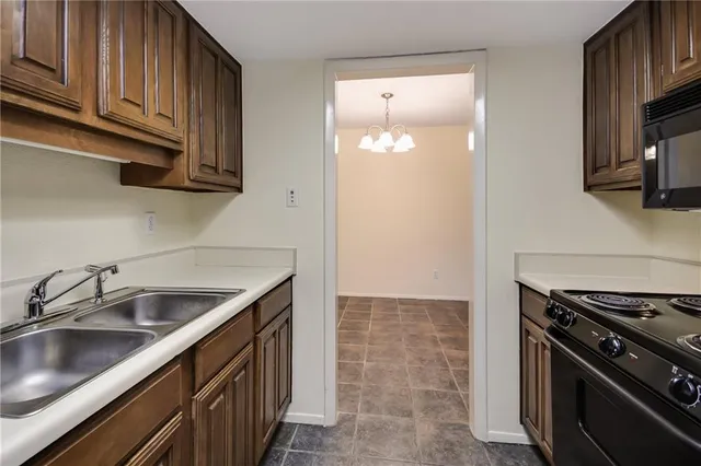 a kitchen with a sink stove and cabinets