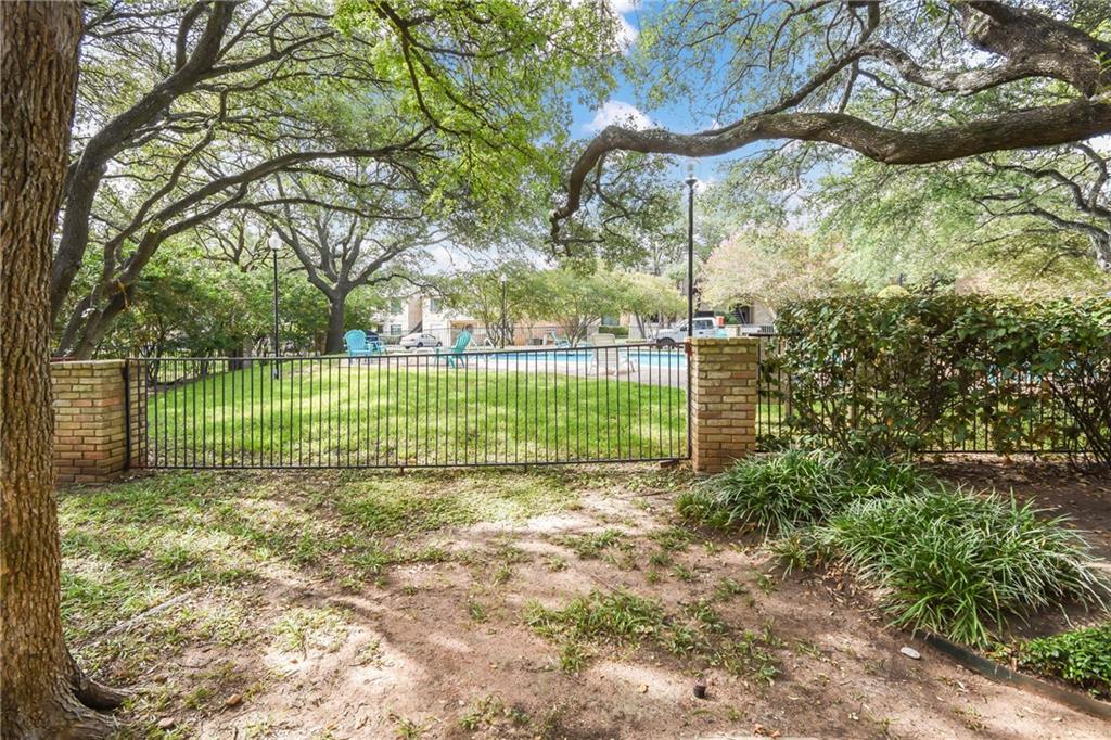 8210 Bent Tree Road, Unit 144 Austin, TX 78759 - Photo 21 of 24 a view of a field with a tree in the background