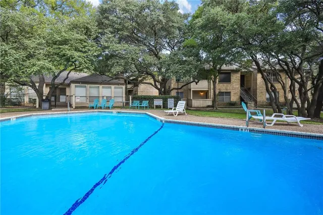 a view of a house with swimming pool and sitting area