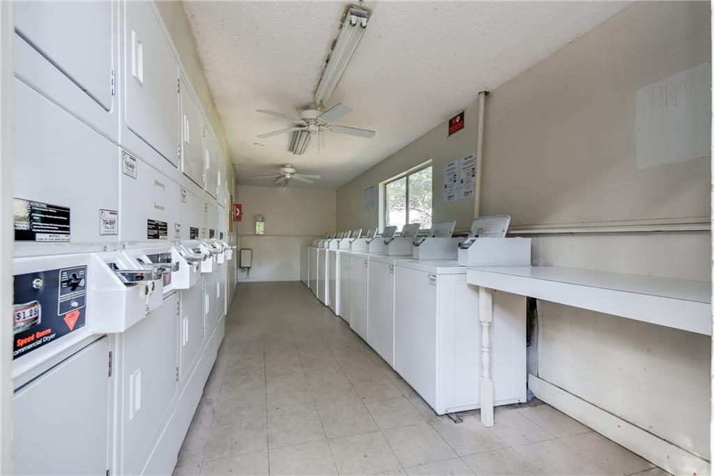 8210 Bent Tree Road, Unit 144 Austin, TX 78759 - Photo 24 of 24 a kitchen with stainless steel appliances a sink stove and cabinets