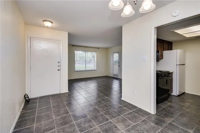 a view of a kitchen with a sink and a refrigerator a cabinets