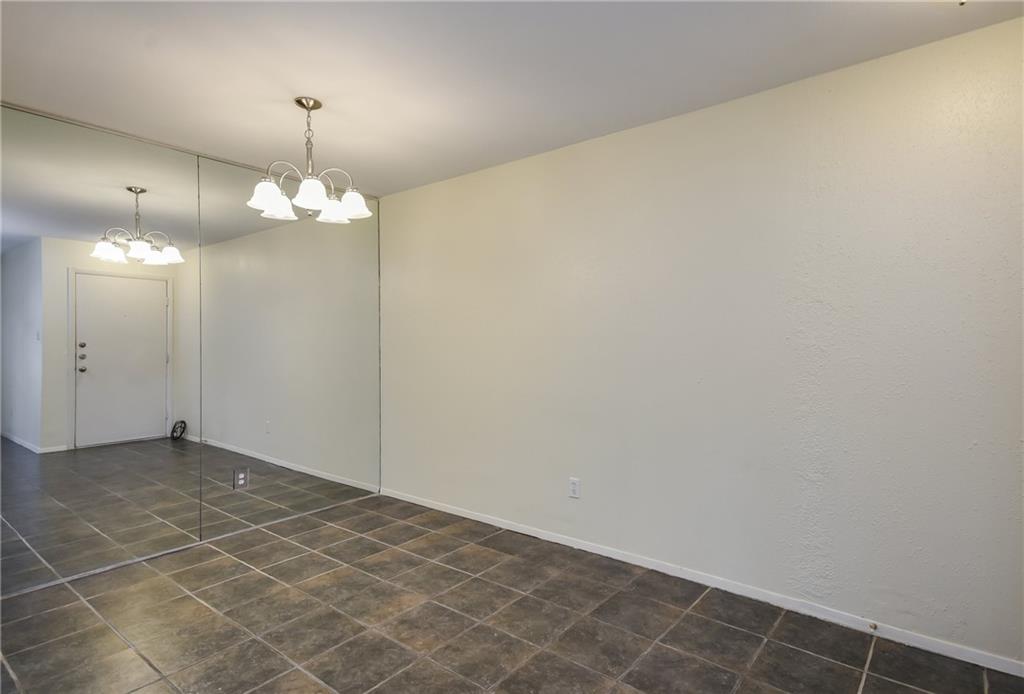8210 Bent Tree Road, Unit 144 Austin, TX 78759 - Photo 4 of 24 an empty room with wooden floor and mirror