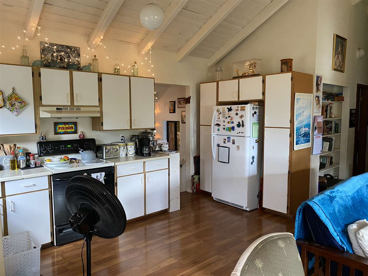 51 Kulalani Circle Kula, HI 96790 - Photo 23 of 30 a kitchen with stainless steel appliances granite countertop a refrigerator a stove a sink dishwasher and white cabinets with wooden floor