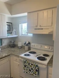 a kitchen with a stove and a white cabinet