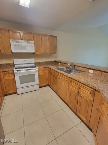 a kitchen with stainless steel appliances a refrigerator and cabinets