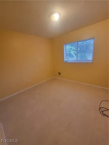 an empty room with a empty space and a window