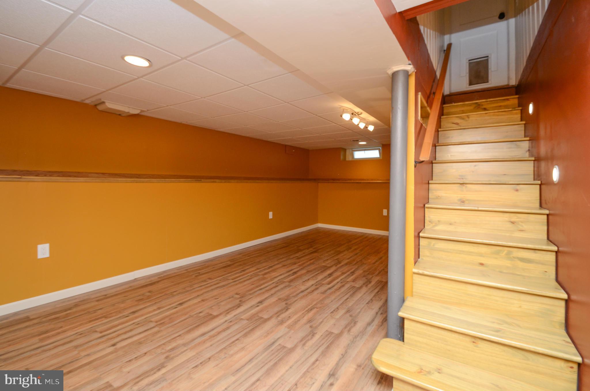 8107 Hillendale Road Baltimore, MD 21234 - Photo 7 of 30 a view of an empty room with wooden floor and a window