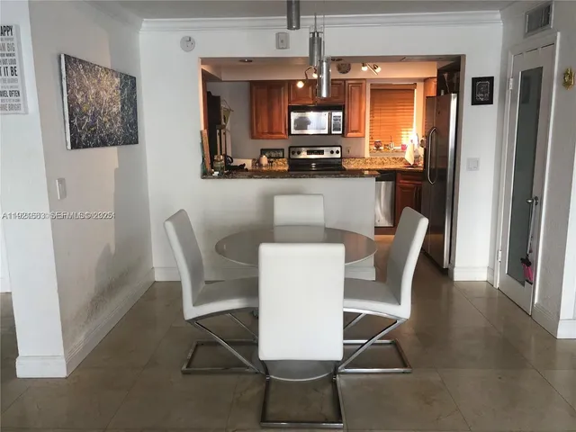 a bathroom with a granite countertop sink and a toilet