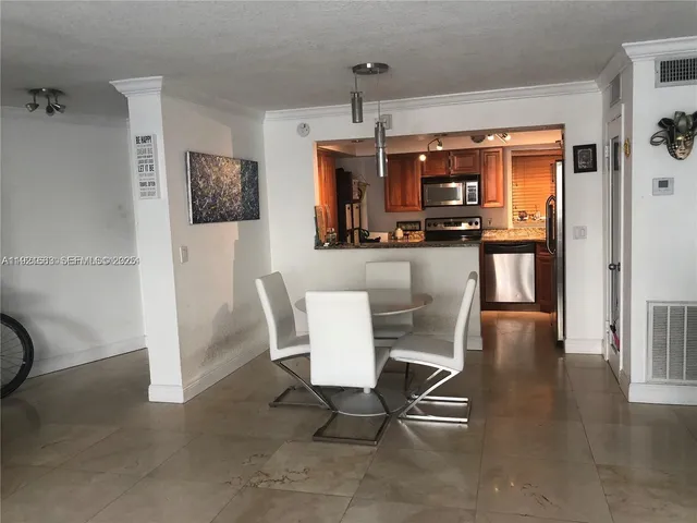 a kitchen with granite countertop cabinets and window
