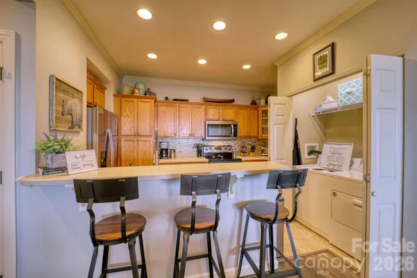 a living room with furniture a rug and a flat screen tv