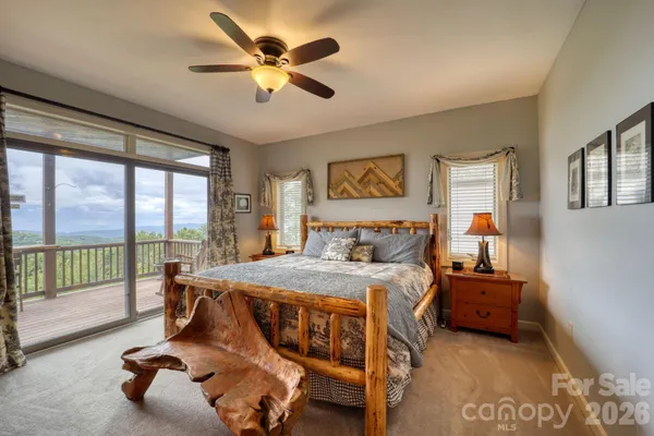 a bedroom with a bed and a large window