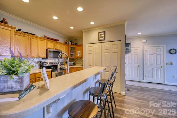 a kitchen with stainless steel appliances granite countertop a stove a sink and a refrigerator