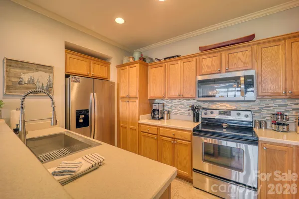 a kitchen with appliances cabinets and chair