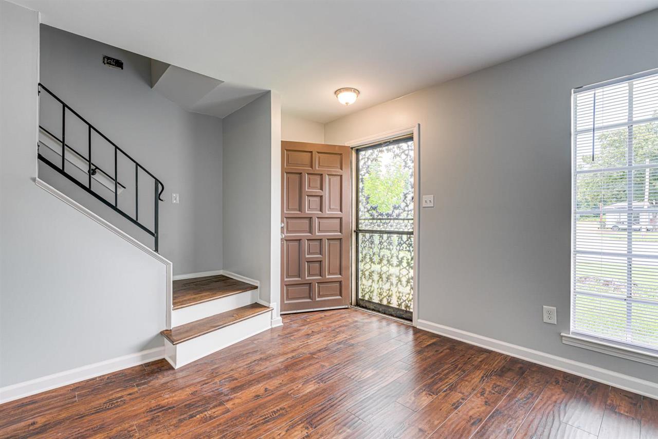 5565 Pleasant View Road, Unit 5565 Memphis, TN 38134 - Photo 1 of 25 a view of an empty room with wooden floor and a window