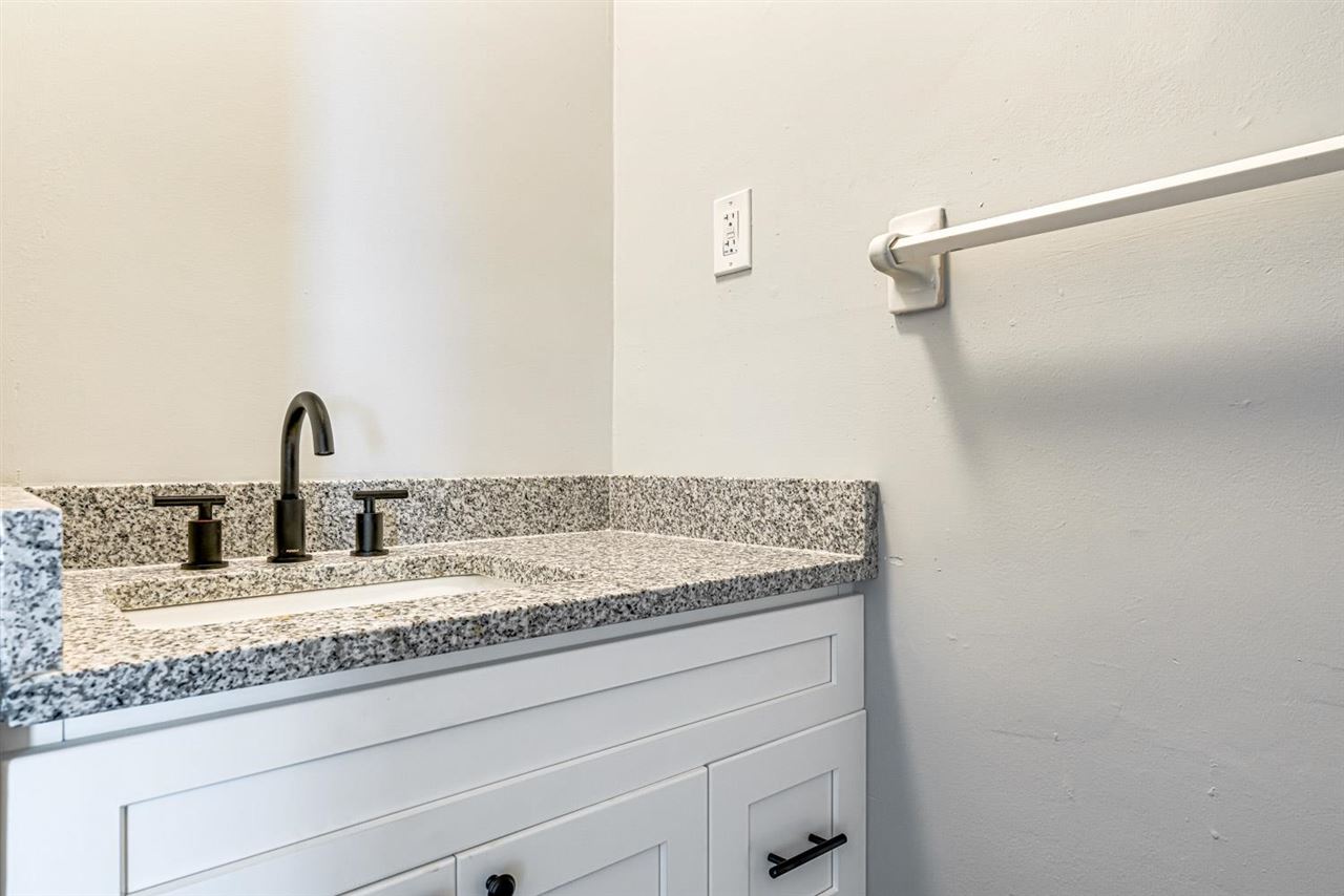5565 Pleasant View Road, Unit 5565 Memphis, TN 38134 - Photo 11 of 25 a bathroom with a granite countertop sink and white cabinets