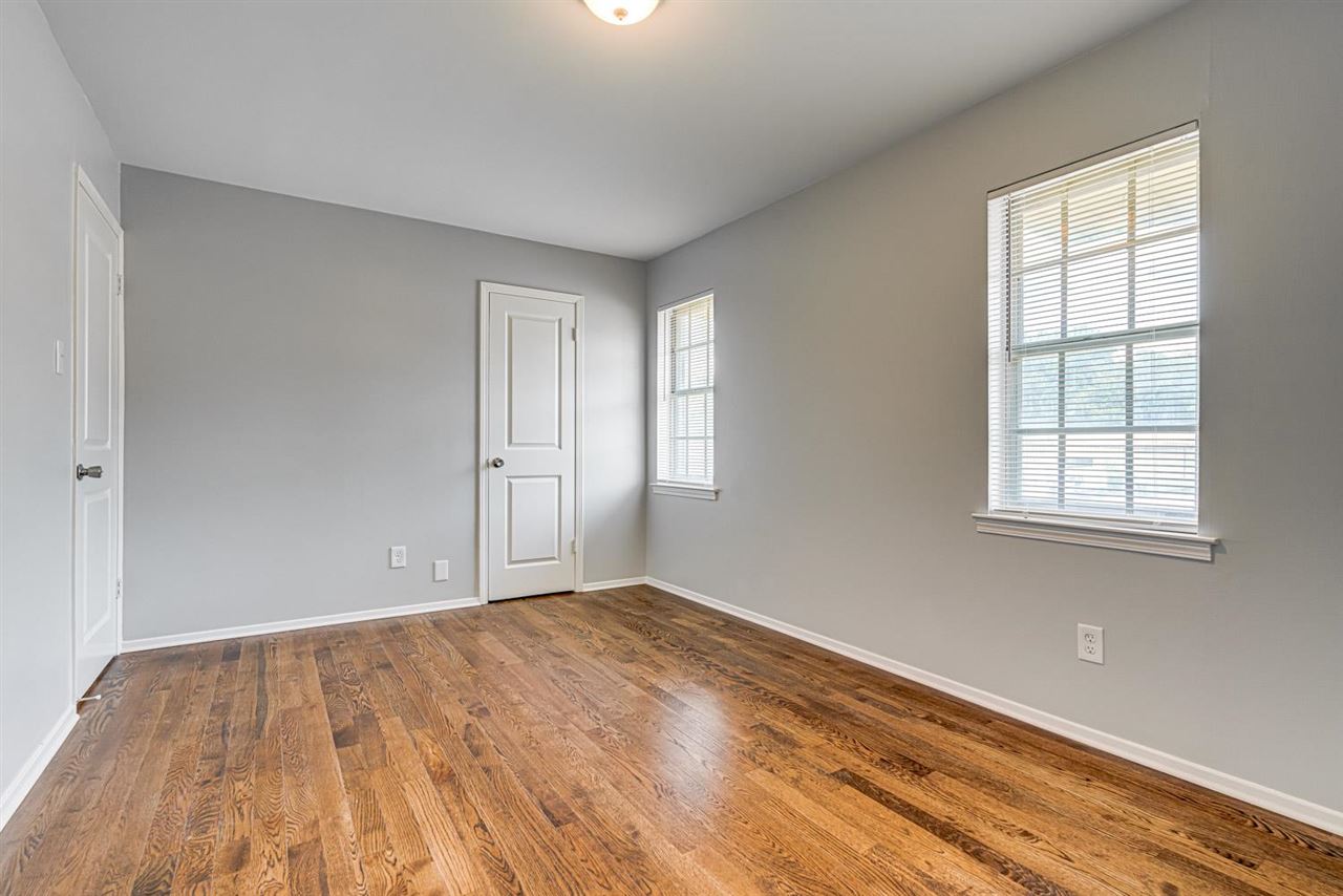 5565 Pleasant View Road, Unit 5565 Memphis, TN 38134 - Photo 12 of 25 an empty room with wooden floor and windows