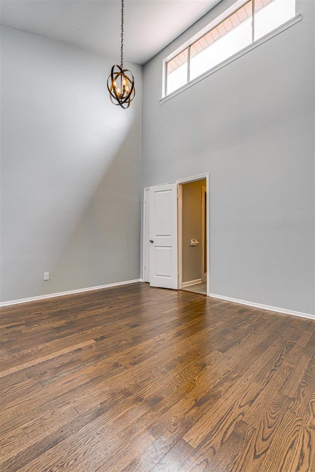 5565 Pleasant View Road, Unit 5565 Memphis, TN 38134 - Photo 14 of 25 a view of an empty room with window and wooden floor