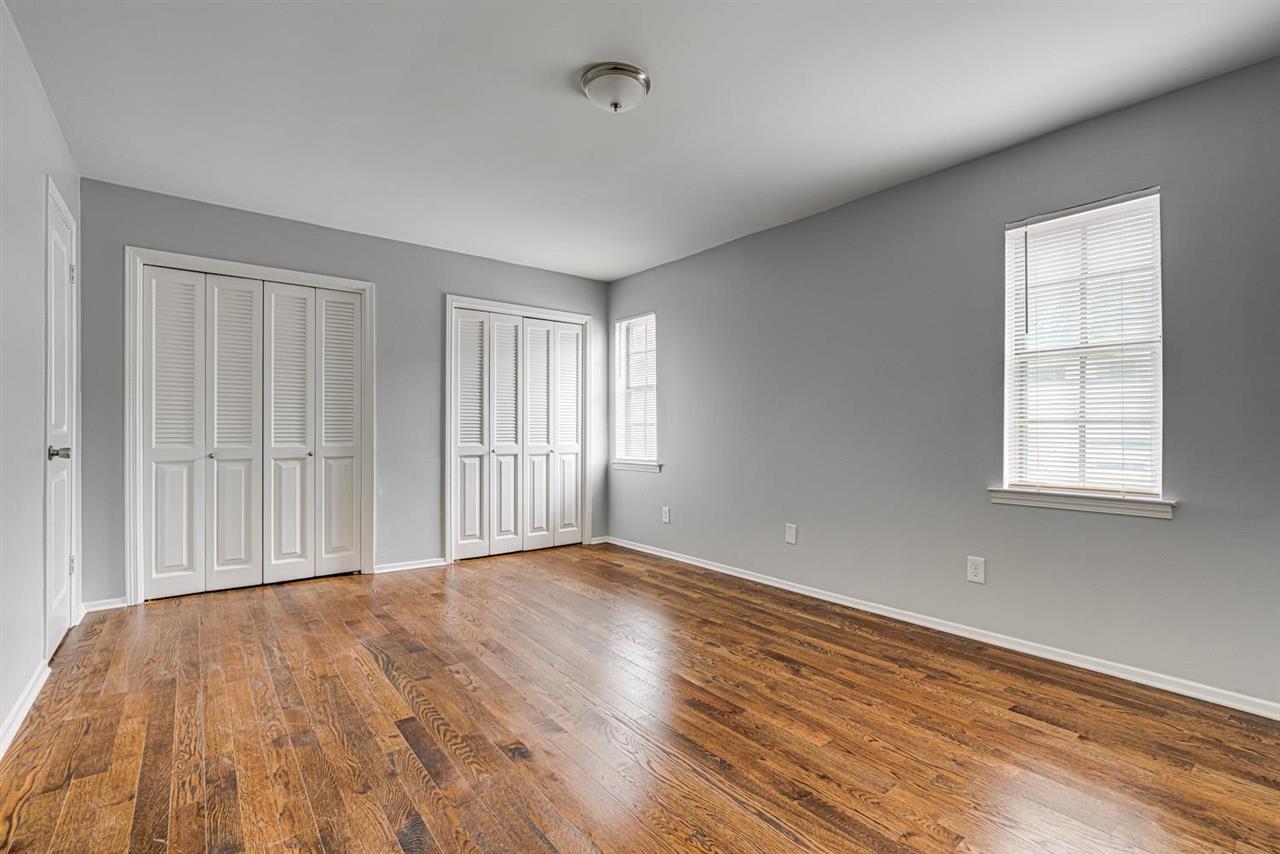 5565 Pleasant View Road, Unit 5565 Memphis, TN 38134 - Photo 16 of 25 a view of an empty room with wooden floor and a window
