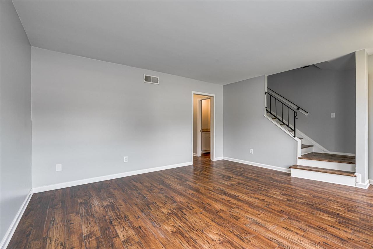 5565 Pleasant View Road, Unit 5565 Memphis, TN 38134 - Photo 3 of 25 a view of an empty room with wooden floor and stairs
