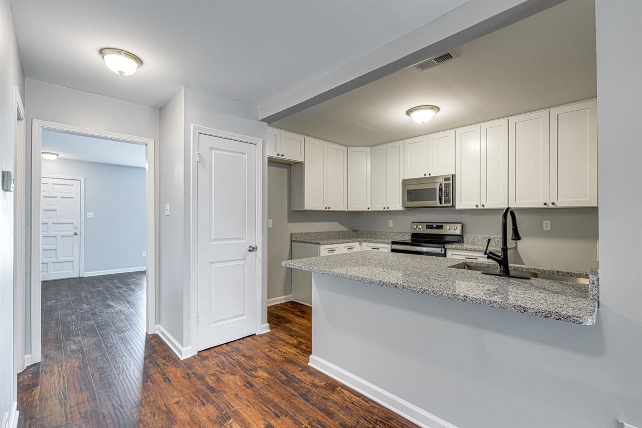5565 Pleasant View Road, Unit 5565 Memphis, TN 38134 - Photo 5 of 25 a kitchen with a refrigerator a stove a microwave and cabinets