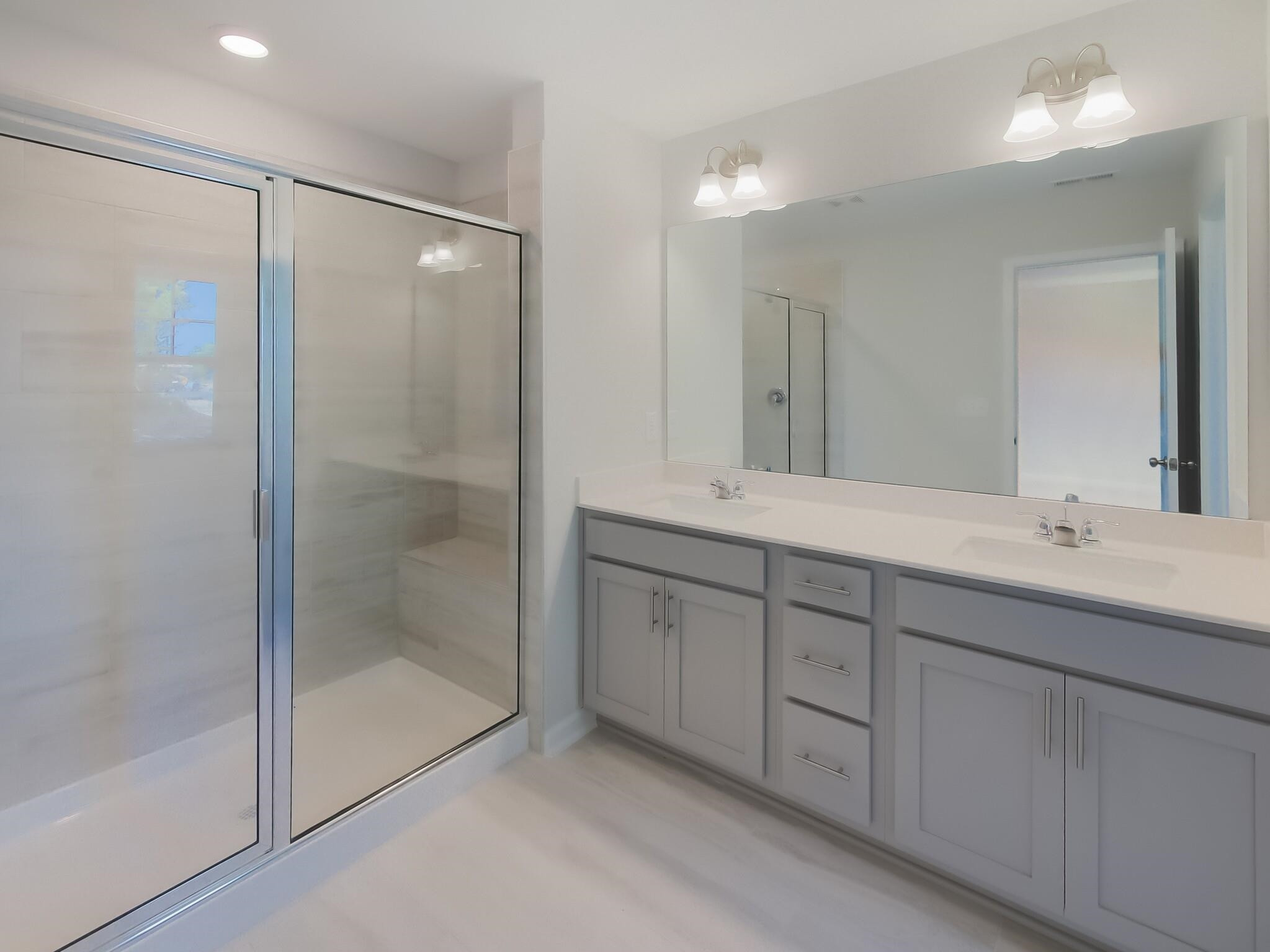 1617 Emory Ridge Way Wake Forest, NC 27587 - Photo 15 of 24 a bathroom with double sink and a mirror