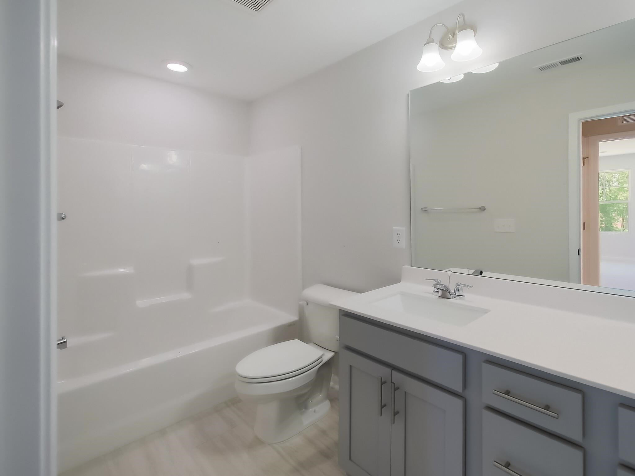 1617 Emory Ridge Way Wake Forest, NC 27587 - Photo 20 of 24 a bathroom with a sink a toilet and shower