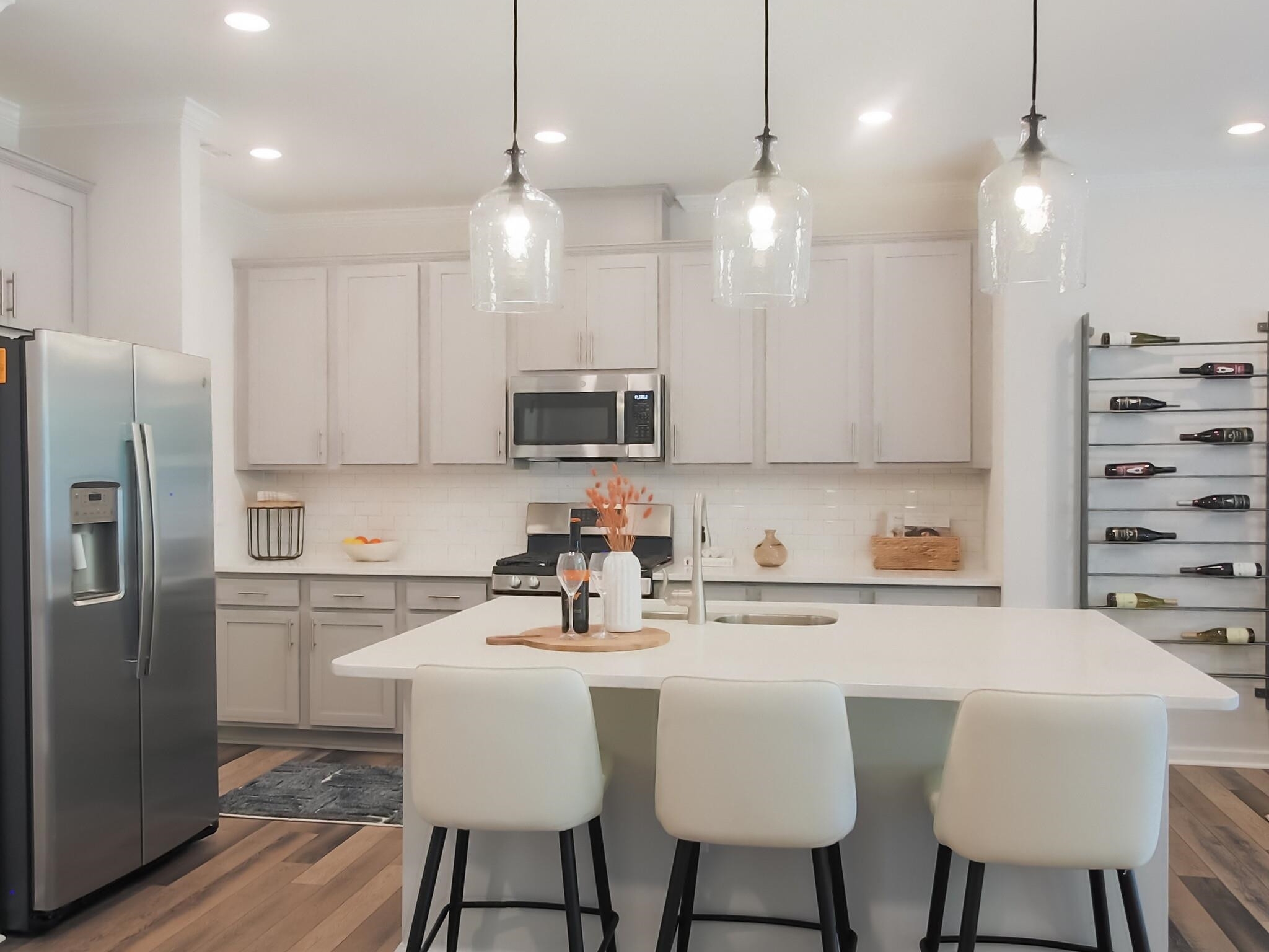 1617 Emory Ridge Way Wake Forest, NC 27587 - Photo 6 of 24 a kitchen with stainless steel appliances a dining table chairs refrigerator and microwave