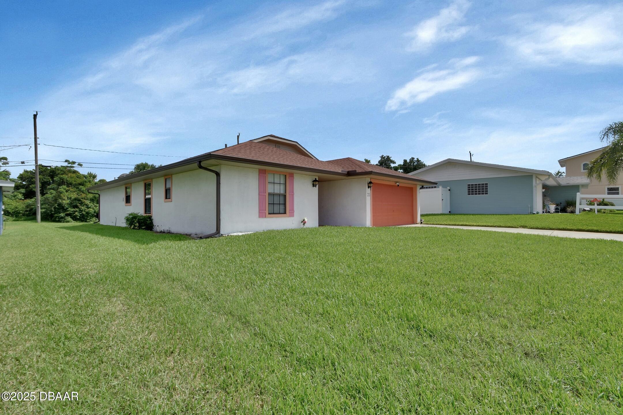 33 Rivocean Drive Ormond Beach, FL 32176 - Photo 19 of 29 a front view of a house with a garden and yard