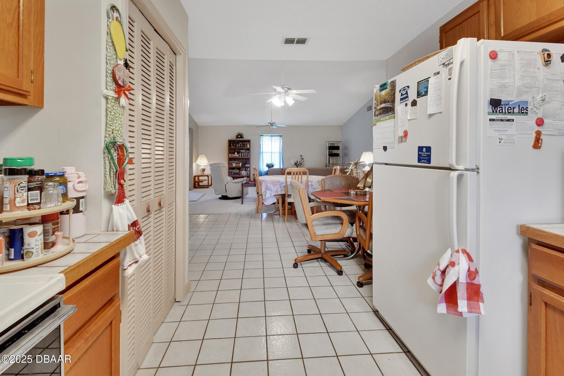 33 Rivocean Drive Ormond Beach, FL 32176 - Photo 6 of 29 a open kitchen with a refrigerator and a sink