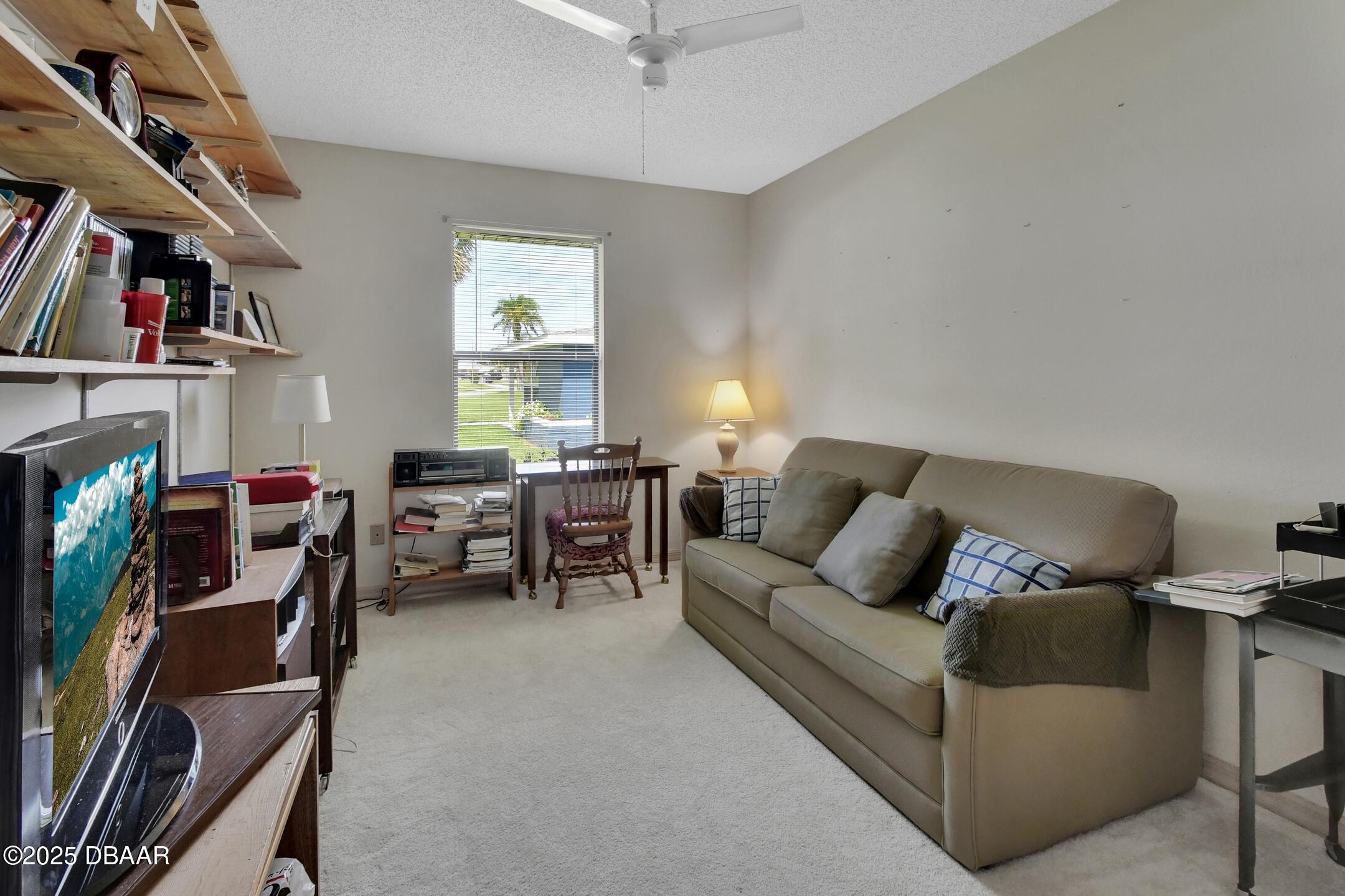 33 Rivocean Drive Ormond Beach, FL 32176 - Photo 9 of 29 a living room with furniture and a bookshelf
