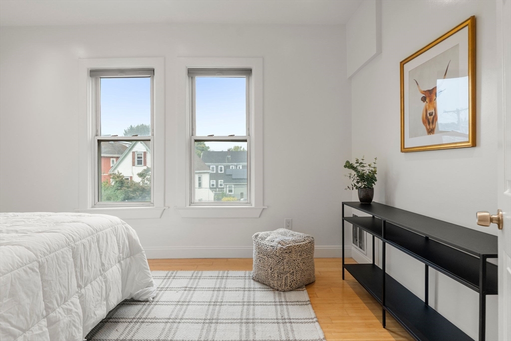 178 Hyde Park Avenue, Unit 3 Boston, MA 02130 - Photo 13 of 23 a bedroom with a bed and a window