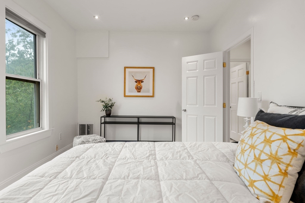 178 Hyde Park Avenue, Unit 3 Boston, MA 02130 - Photo 14 of 23 a bedroom with a bed and a window